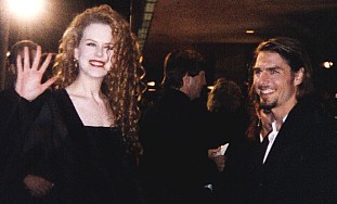 Nicole Kidman waving, Tom Cruise smiling